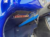 a close up of a blue motorcycle with a blue handlebar