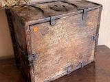 a wooden box sitting on a table next to a pillow