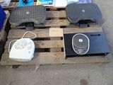 a pile of electronics on a pallet next to other items