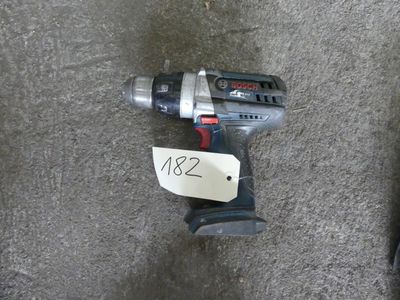 a cordless drill on the ground with a price tag