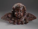 an image of a statue of a child with wings on a gray background