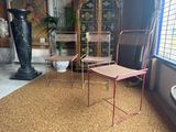 two chairs and a table in a room with a window