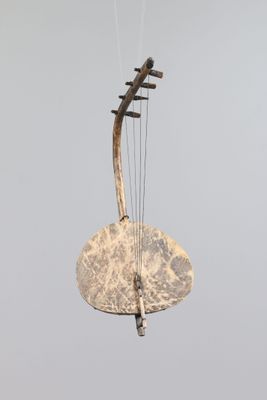 an image of a musical instrument hanging from a string