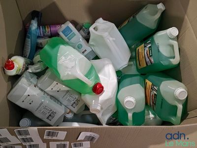 a cardboard box filled with bottles of cleaning products
