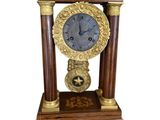 a clock that is sitting on top of a wooden stand