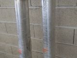 two poles that have been wrapped in plastic on the side of a building