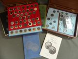 several coins are in a box on a table next to a book