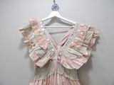 a dress hanging on a hanger on a wall