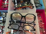 many pairs of glasses sitting in a box on the table