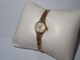 an image of a wrist watch sitting on top of a pillow