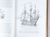an open book with a drawing of a ship on it