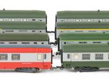 two trains that are sitting side by side on a white surface