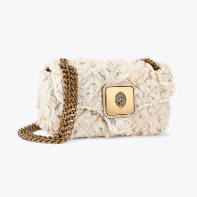 a close up of a handbag with a chain on a white background