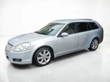 a picture of a silver car parked in a white room