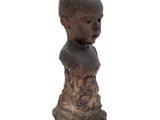 an image of a small statue of a boy with a bald head