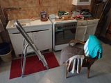 a chair and a ladder in a kitchen that is being remodeled