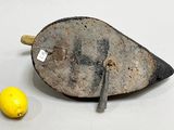 a small yellow lemon next to an old iron object