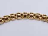 an image of a gold bracelet on a white background