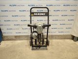 a close up of a machine on a stand in front of a wall