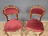 pair of antique chairs with red velvet upholstered seats