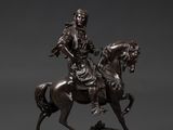 a bronze statue of a man riding a horse on a marble base