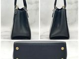 two photos of a black purse with gold hardware on the handles
