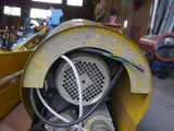 a yellow blower sitting on a pallet in a building