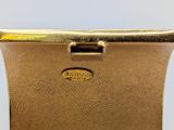 a close up of a gold belt with a gold buckle on it
