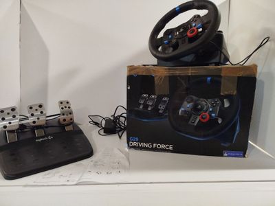 a box with a steering wheel and a game controller on it