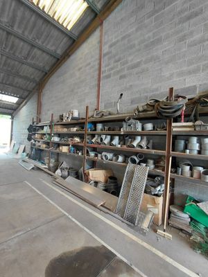 many pots and pans on the shelves in the warehouse