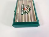 a silver and green electronic device sitting on a white surface