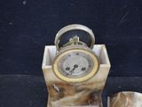 a marble clock sitting on top of a marble block
