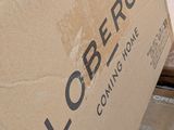 a cardboard box sitting on top of a pile of boxes
