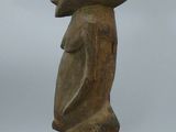 an image of a wooden sculpture of a man ' s head on a stand