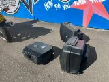 three pieces of luggage sitting on the ground next to a scooter