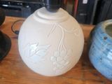 two vases sitting on a table next to each other