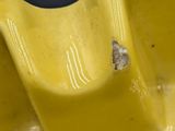 a yellow sink with a butterfly on it and a black background