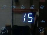 a close up of a microwave with a digital clock on it