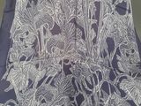 a blue and white floral design on the back of a chair