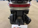 a motorcycle that is parked in a lot with a sign