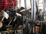 many chairs and stools in a room with a lot of them
