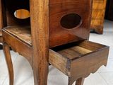 a small wooden table with a drawer on top of it