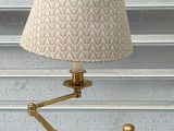 a lamp that is on a table with a lamp shade on it
