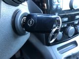 a car key that is attached to the steering wheel of a car
