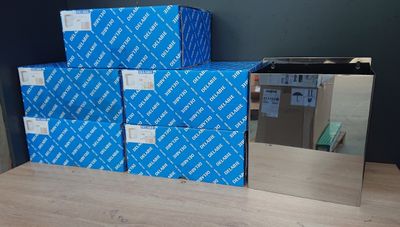 a stack of blue boxes sitting on a table next to a mirror