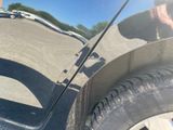 a reflection of a person on the side of a car