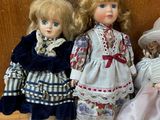 three dolls sitting next to each other on a table
