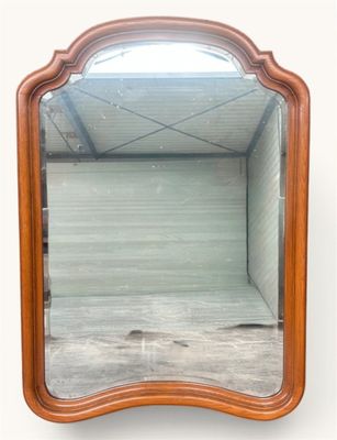 an image of a mirror with a wooden frame on a white wall