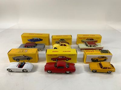 several toy cars are lined up in a row on a white surface