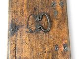 an old book with a ring on the front of it